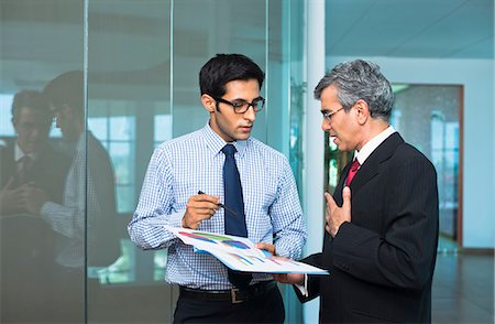 simsearch:630-07071502,k - Businessmen discussing a report Stock Photo - Premium Royalty-Free, Code: 630-07071454