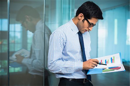 filing - Businessman reading a report Stock Photo - Premium Royalty-Free, Code: 630-07071453