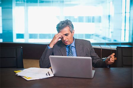 simsearch:630-07071502,k - Worried businessman sitting with laptop Stock Photo - Premium Royalty-Free, Code: 630-07071486