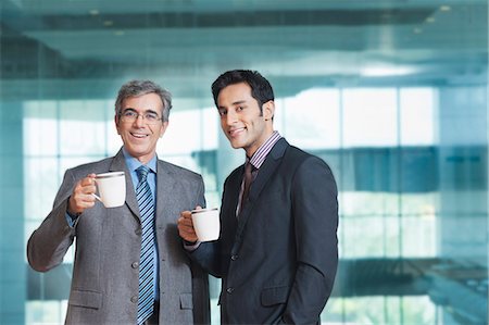 simsearch:630-07071502,k - Two businessmen having coffee and smiling Stock Photo - Premium Royalty-Free, Code: 630-07071566