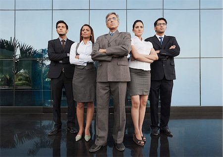 Business people standing together with their arms crossed Stock Photo - Premium Royalty-Free, Code: 630-07071586