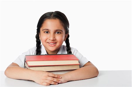 simsearch:630-07071771,k - Girl leaning on books and smiling Stock Photo - Premium Royalty-Free, Code: 630-07071799