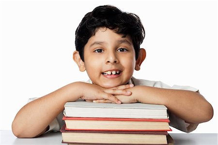 simsearch:630-07071771,k - Boy leaning on books and smiling Stock Photo - Premium Royalty-Free, Code: 630-07071800