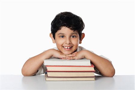 simsearch:630-07071771,k - Boy leaning on books and smiling Stock Photo - Premium Royalty-Free, Code: 630-07071801