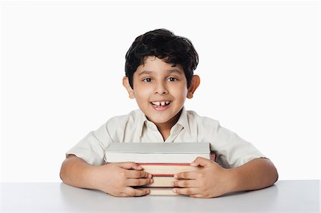 simsearch:630-07071771,k - Boy leaning on books and smiling Stock Photo - Premium Royalty-Free, Code: 630-07071802
