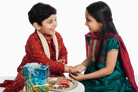 simsearch:630-07071771,k - Girl tying rakhi on her brother wrist Stock Photo - Premium Royalty-Free, Code: 630-07071820