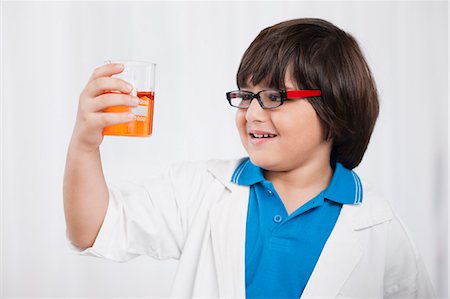 simsearch:630-07071771,k - Boy holding a beaker of chemical and imitating like a scientist Stock Photo - Premium Royalty-Free, Code: 630-07071842