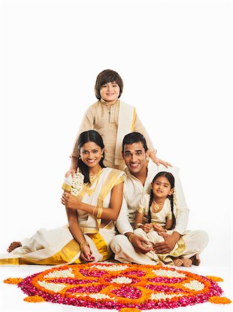 South Indian family making a rangoli of flowers at Onam Stock Photo - Premium Royalty-Free, Code: 630-07071862