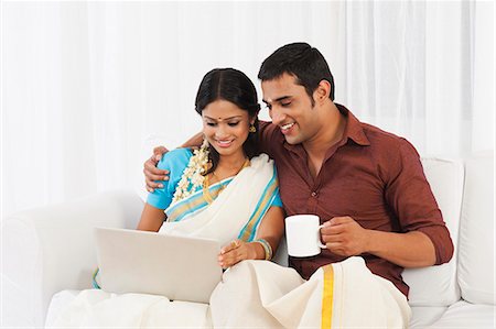 South Indian couple using a laptop Stock Photo - Premium Royalty-Free, Code: 630-07071893