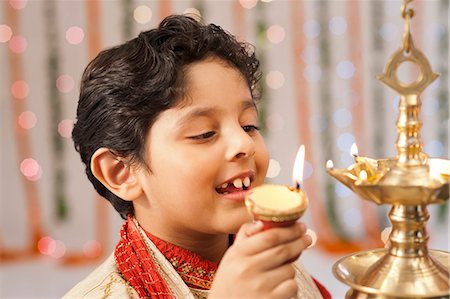 simsearch:700-00195618,k - Boy burning oil lamps on Diwali Stock Photo - Premium Royalty-Free, Code: 630-07071953