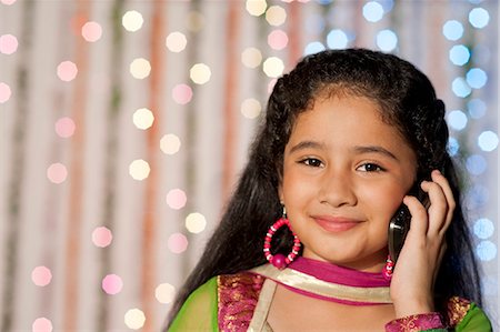 simsearch:700-00195618,k - Girl talking on a mobile phone on Diwali Stock Photo - Premium Royalty-Free, Code: 630-07071969