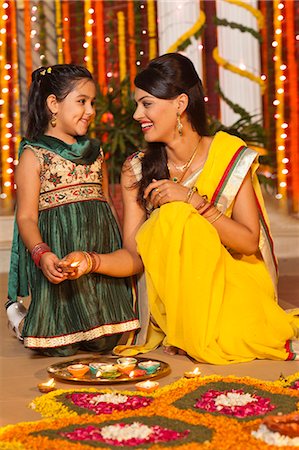 flower for mom asian - Woman and her daughter decorating rangoli with oil lamps on Diwali Stock Photo - Premium Royalty-Free, Code: 630-07072011