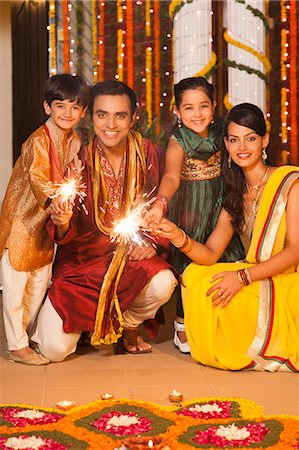 saree couples - Family burning fire crackers on Diwali Stock Photo - Premium Royalty-Free, Code: 630-07072024