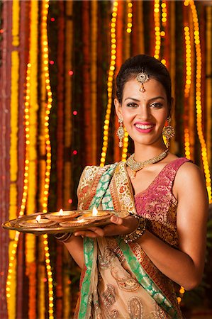 festival photo indian - Woman holding a plate of oil lamps on Diwali Stock Photo - Premium Royalty-Free, Code: 630-07072029