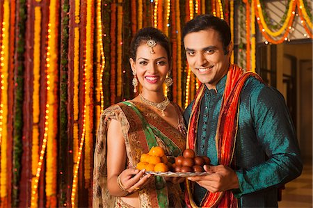 Couple holding a plate of sweets on Diwali Stock Photo - Premium Royalty-Free, Code: 630-07072038