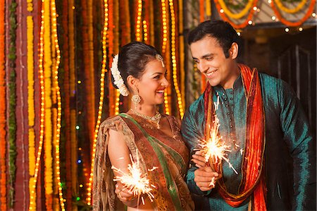 saree couples - Couple burning fire crackers on Diwali Stock Photo - Premium Royalty-Free, Code: 630-07072032