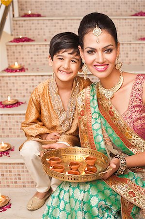 footprints of two people - Woman and her son decorating with oil lamps on Diwali Stock Photo - Premium Royalty-Free, Code: 630-07072044