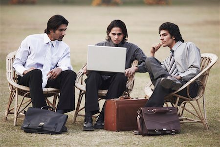 simsearch:630-06724175,k - Three businessmen using a laptop Stock Photo - Premium Royalty-Free, Code: 630-01075941