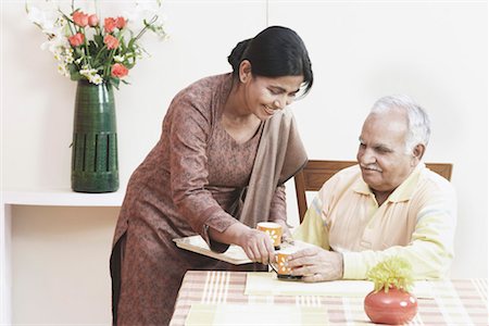 simsearch:630-01076466,k - Mature woman serving tea to a mature man Stock Photo - Premium Royalty-Free, Code: 630-01076539
