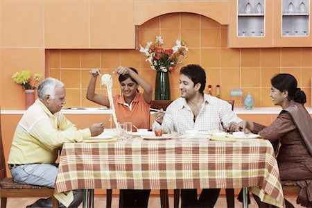 simsearch:630-01076466,k - Side profile of a mature couple and their two children at the dining table Stock Photo - Premium Royalty-Free, Code: 630-01076547