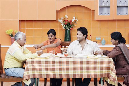 simsearch:630-01076466,k - Side profile of a mature couple and their two children at the dining table Stock Photo - Premium Royalty-Free, Code: 630-01076548