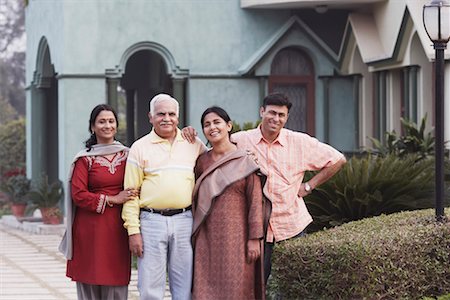 simsearch:630-01076466,k - Portrait of a mature couple and their two children standing in front of a house Stock Photo - Premium Royalty-Free, Code: 630-01076584