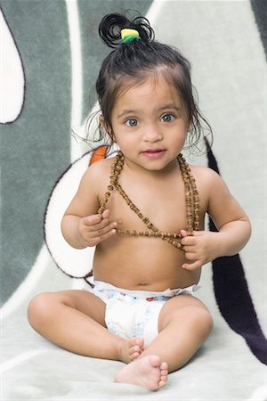 Portrait of a baby girl wearing a necklace Stock Photo - Premium Royalty-Free, Code: 630-01079581