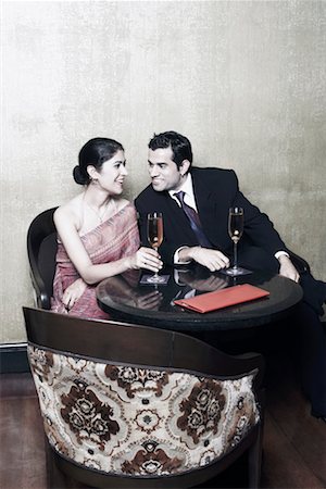 shirt collar - Businessman and a businesswoman sitting on chairs with champagne flutes Foto de stock - Sin royalties Premium, Código: 630-01080016