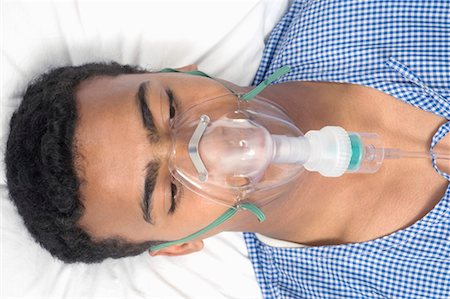 Close-up of a patient wearing an oxygen mask Stock Photo - Premium Royalty-Free, Code: 630-01080066