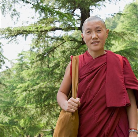 Close-up of a mid adult man smiling, McLeod Ganj, Dharmakot, Dharamshala, Himachal Pradesh, India Stock Photo - Premium Royalty-Free, Code: 630-01126859