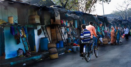 slums - Rear view of two men cycling on the street, Mumbai, Maharashtra, India Stock Photo - Premium Royalty-Free, Code: 630-01127259