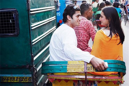 phone with indian man backside - Rear view of a young couple sitting in a rickshaw Stock Photo - Premium Royalty-Free, Code: 630-01127943