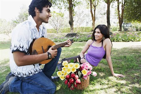 picture of the blue playing a instruments - Young man playing the mandolin with a young woman looking at him Stock Photo - Premium Royalty-Free, Code: 630-01128863