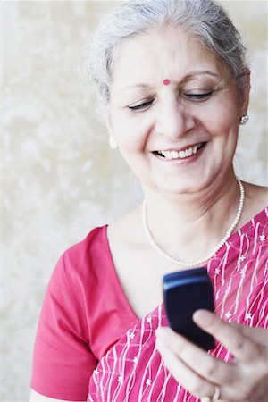 simsearch:630-01076466,k - Close-up of a mature woman holding a mobile phone Stock Photo - Premium Royalty-Free, Code: 630-01130341