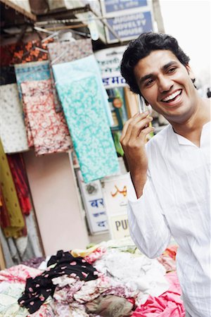 Close-up of a young man talking on a mobile phone Stock Photo - Premium Royalty-Free, Code: 630-01130936