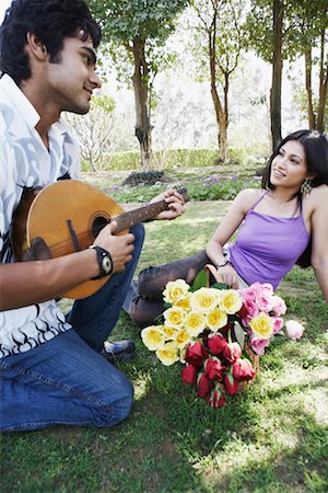 picture of the blue playing a instruments - Young man playing the mandolin with a young woman looking at him Stock Photo - Premium Royalty-Free, Code: 630-01131319