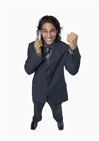 simsearch:640-01350815,k - High angle view of a businessman talking on a mobile phone and clenching his fist Stock Photo - Premium Royalty-Free, Code: 630-01191688