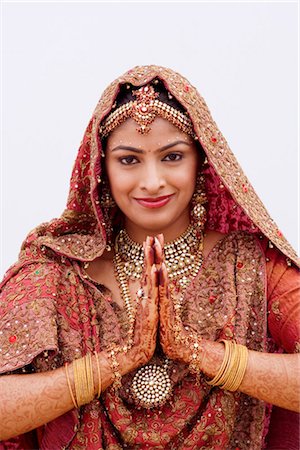 simsearch:700-03567853,k - Portrait of a bride greeting in a traditional wedding dress Stock Photo - Premium Royalty-Free, Code: 630-01192922