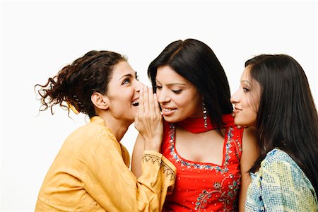 Close-up of three young women gossiping Stock Photo - Premium Royalty-Free, Code: 630-01296818