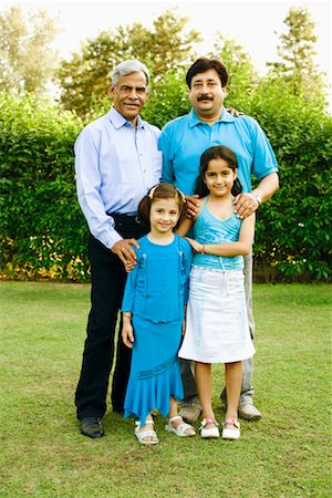 Portrait of two girls with their father and grandfather standing in a park Stock Photo - Premium Royalty-Free, Code: 630-01296848