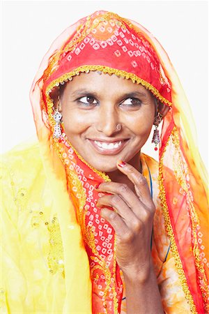 rajasthan clothes for women - Close-up of a young woman looking away and smiling Stock Photo - Premium Royalty-Free, Code: 630-01490624