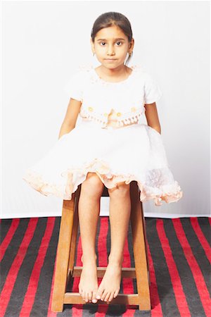 Portrait of a girl sitting on a stool Stock Photo - Premium Royalty-Free, Code: 630-01490636
