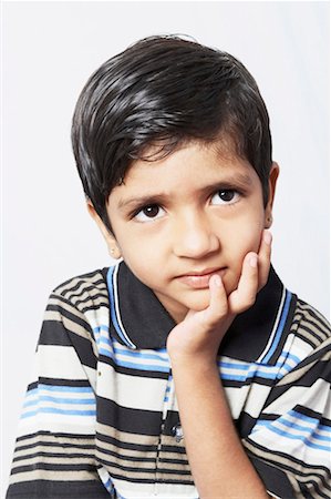 simsearch:630-01491544,k - Close-up of a boy contemplating with his hand on his chin Stock Photo - Premium Royalty-Free, Code: 630-01490633