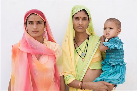 rajasthan female models - Portrait of a young woman carrying her daughter with another young woman standing beside them Stock Photo - Premium Royalty-Free, Code: 630-01490711