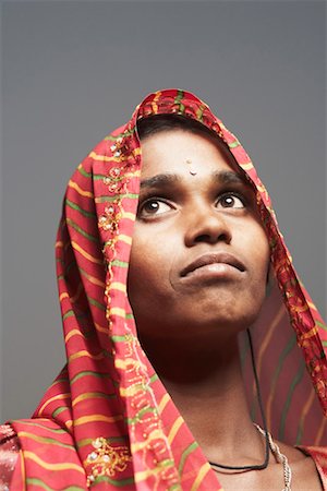 rajasthan clothes for women - Close-up of a young woman looking up Stock Photo - Premium Royalty-Free, Code: 630-01490757