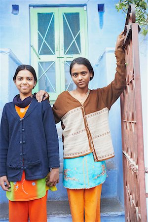 Portrait of two teenage girls standing at a gate Stock Photo - Premium Royalty-Free, Code: 630-01490774