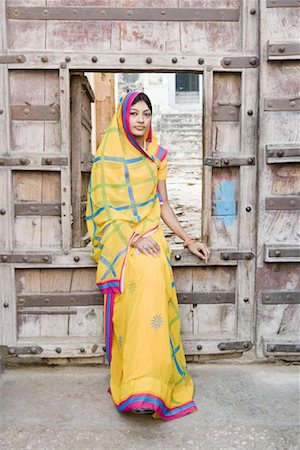 rajasthan clothes for women - Portrait of a young woman sitting at a doorway Stock Photo - Premium Royalty-Free, Code: 630-01490777
