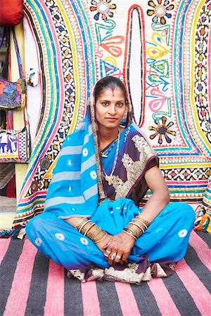 rajasthan clothes for women - Portrait of a young woman sitting cross-legged on a mat Stock Photo - Premium Royalty-Free, Code: 630-01490778