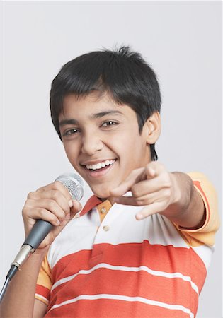 simsearch:630-01491544,k - Portrait of a boy singing in front of a microphone Stock Photo - Premium Royalty-Free, Code: 630-01491541