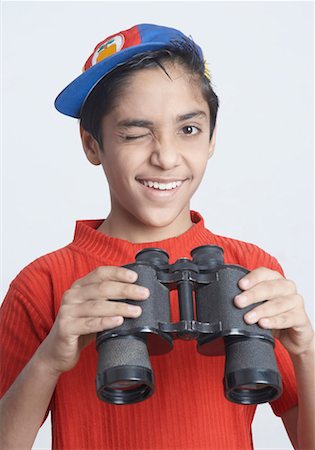 simsearch:630-01491544,k - Portrait of a boy holding a pair of binoculars Stock Photo - Premium Royalty-Free, Code: 630-01491553